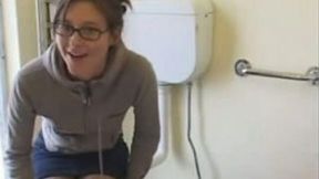 Nerdy college girl is in the public toilet after morning exercise