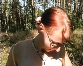 Amazing redhead with small tits masturbates her wet pussy with a dildo outdoors
