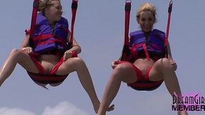 Wild exhibitionists flashing their tits and bare pussies while parasailing on a public beach